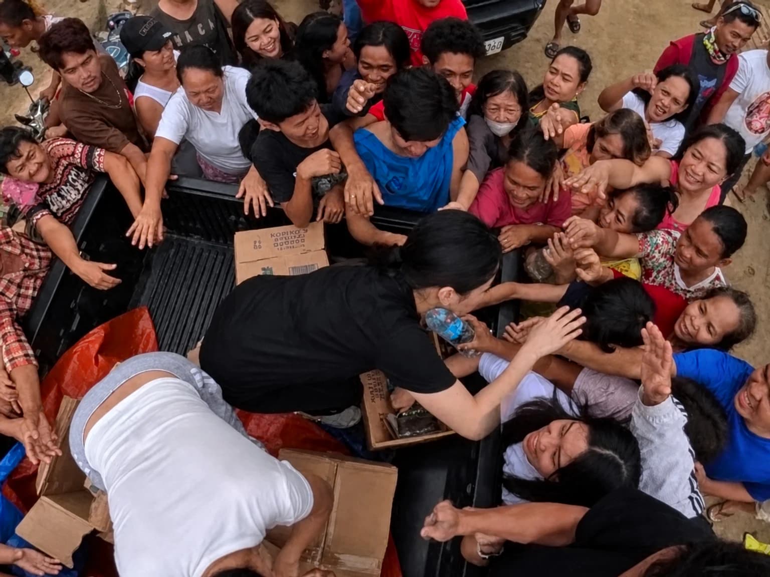 May Bukas Pa volunteer handing relief goods to a community